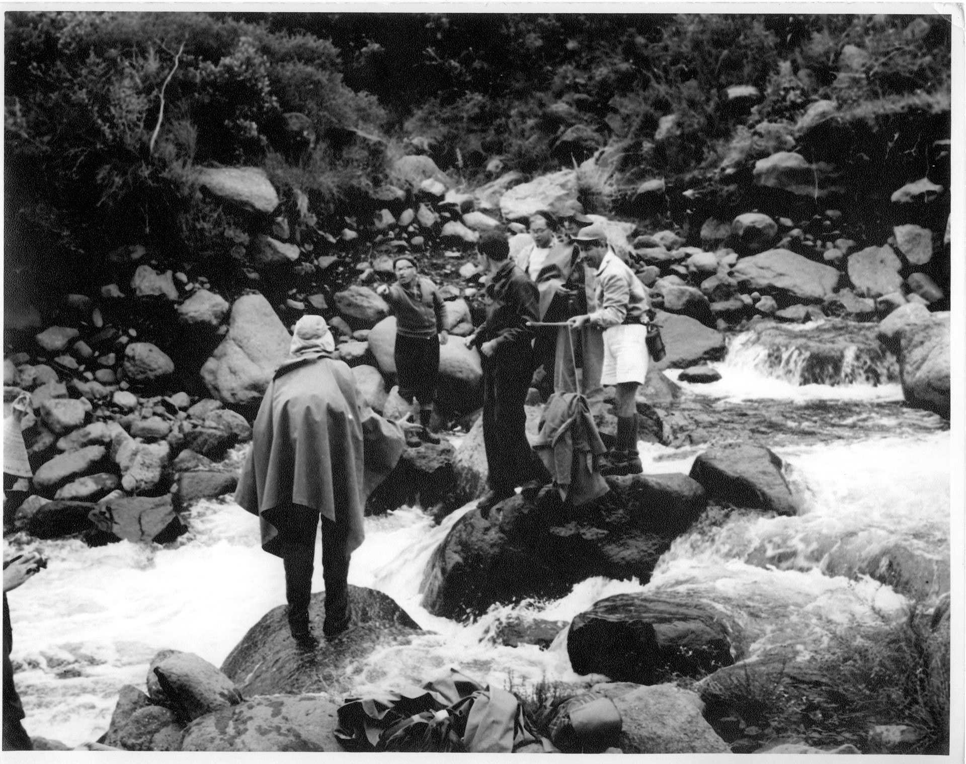 Walking group cross river in Basutoland.