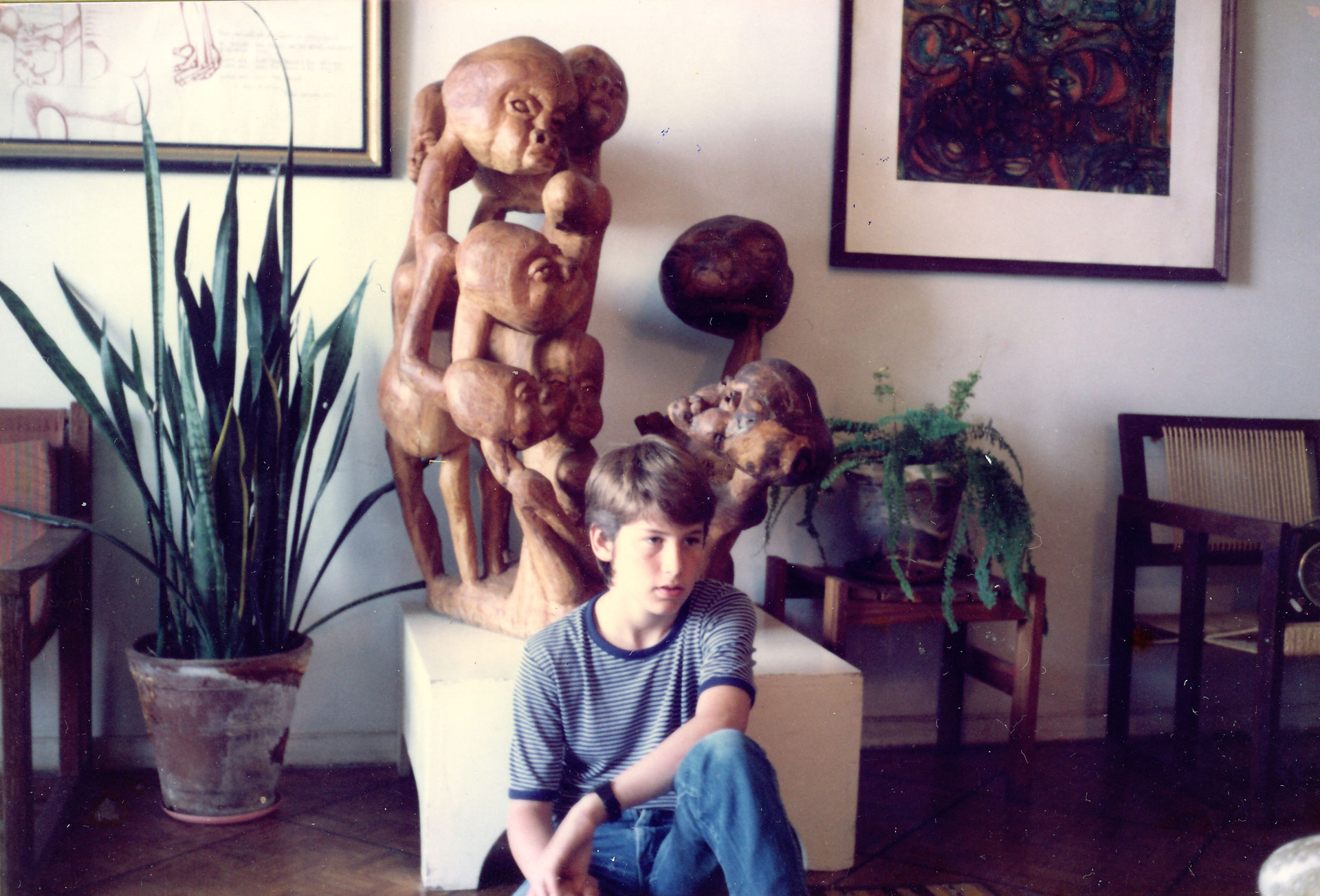 Alan Sachs sits in front of Chissano sculpture in Albie’s apartment in Maputo.