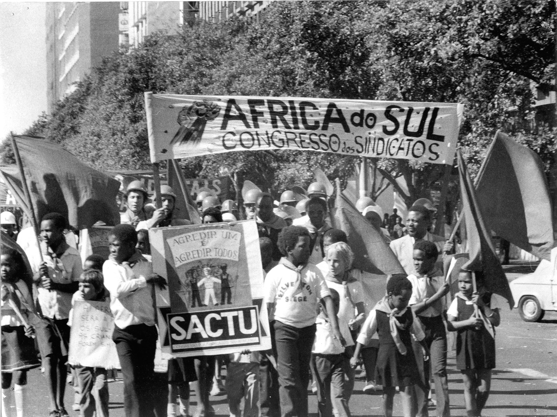 Albie marches in SACTU May Day march, Maputo, Mozambique. John Nkadimeng holding banner on right.