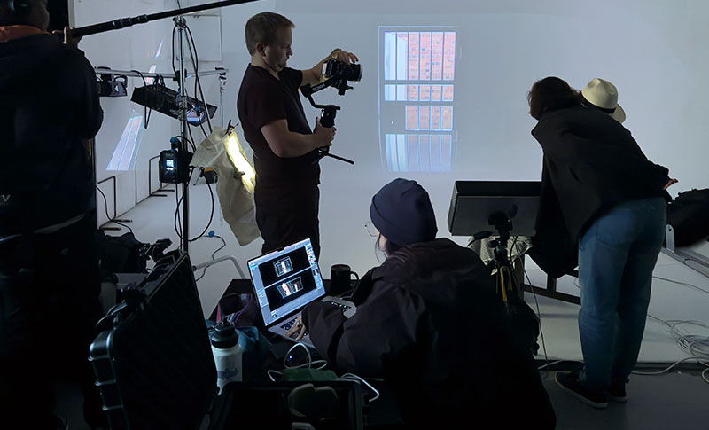 Albie watching rojection of video clip from within Maitland prison cell in studio