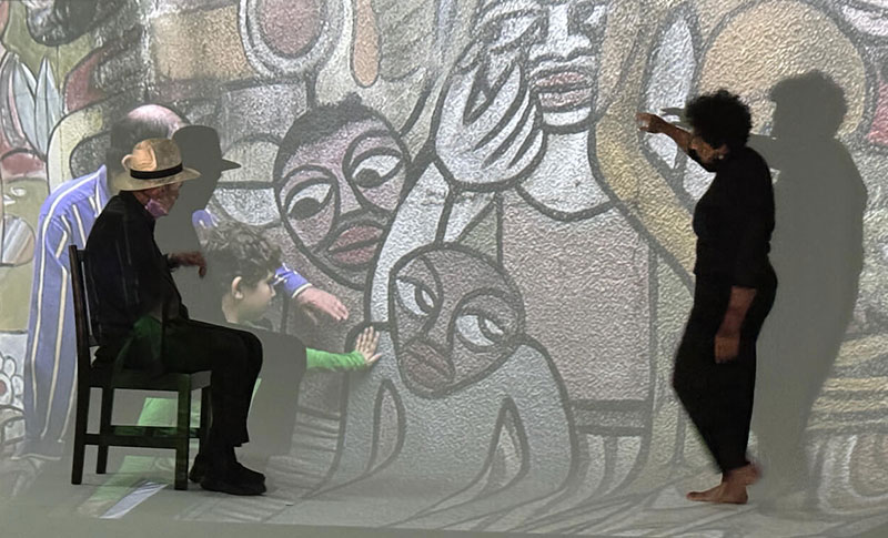 Albie and Vanessa with film projection of Albie and young Oliver at Maputo Mural